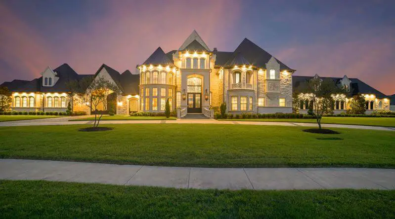 large fancy home at night lit up