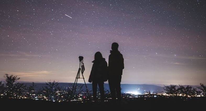 a couple star gazing at night 