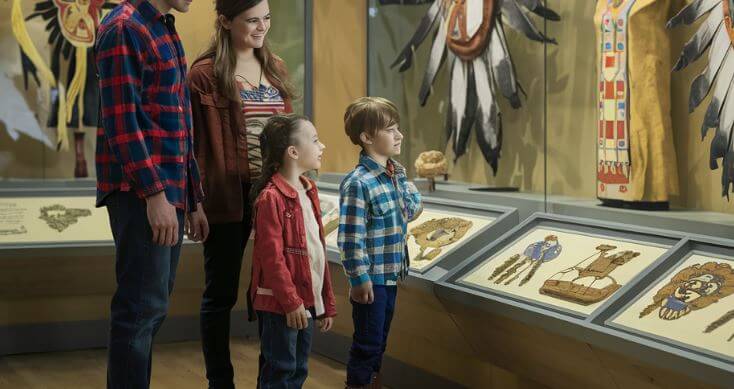 family looking at native american art display