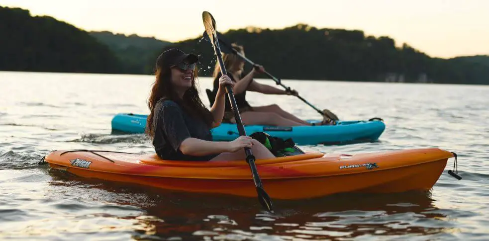2 women kayaking on a a lake