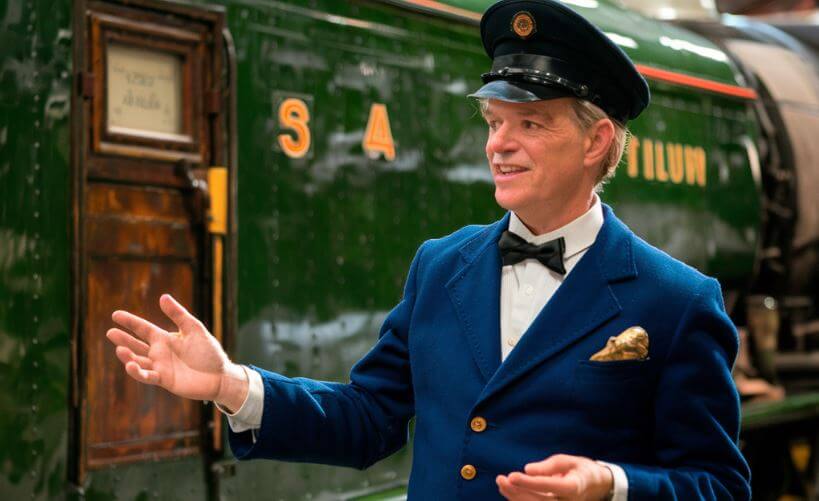 train conductor showing a vintage locomotive