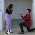 man getting on one knee proposing marriage to woman