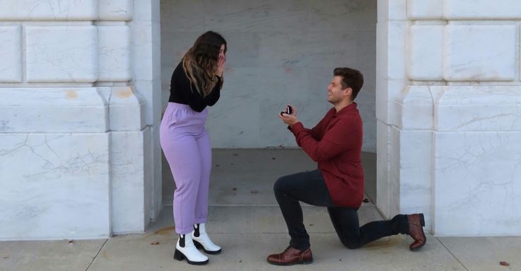 man getting on one knee proposing marriage to woman